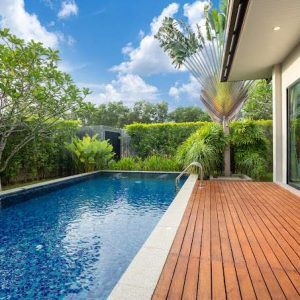 swimming pool and decking in garden of luxury home